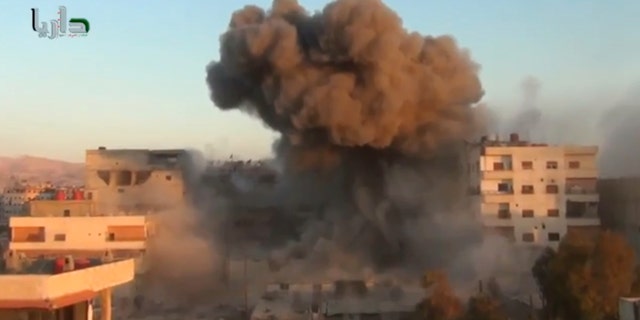 In this image taken from video obtained from the Shaam News Network, which has been authenticated based on its contents and other AP reporting, smoke billows amid buildings at a bomb explosion in Daraya, a countryside of Damscus, Syria, Tuesday, Oct. 15, 2013. Syrian warplanes bombed several rebel-held areas Tuesday and opposition fighters fired mortar rounds and homemade rockets at Damascus on the first day of a major Muslim holiday, activists said. (AP Photo/Shaam News Network via AP Video)