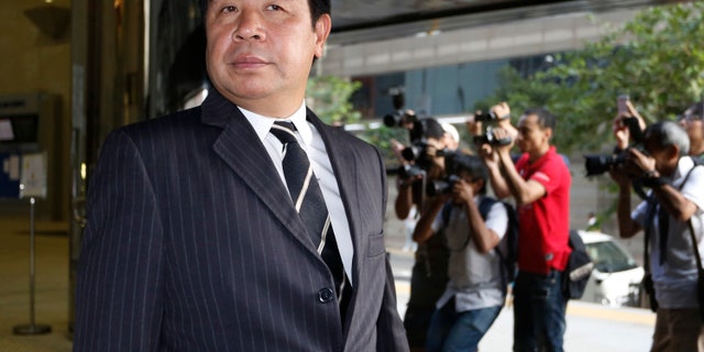 FILE - In this Tuesday, Oct. 15, 2013 file photo, Birmingham City F.C. owner Carson Yeung leaves Hong Kong District Court in Hong Kong after giving testimony in his money laundering trial. Yeung said he’s a celebrity hairdresser, property developer, casino high-roller and millionaire stock investor. Hong Kong prosecutors said the owner of the football club is a money launderer who grossly inflated his income. (AP Photo/Vincent Yu, File)