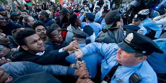 Protesters rush a police line after a rally at City Hall in Philadelphia on Thursday, April 30, 2015. The event in Philadelphia follows days of unrest in Baltimore amid Freddie Gray's police-custody death. (AP Photo/Matt Rourke)