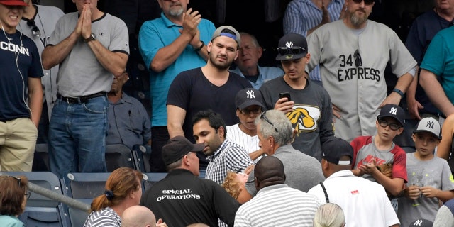 Fans react after a foul ball struck a toddler in the stands at Yankee Stadium.