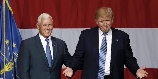 FILE - In this July 12, 2016 file photo, Indiana Gov. Mike Pence joins Republican presidential candidate Donald Trump at a rally in Westfield, Ind. Over the past two decades, Trump has disagreed with his vice-presidential pick on plenty of political issues, including immigration policy, entitlement programs and trade. On social issues above all, Trump and Pence arrive at the 2016 general election from very different paths.  (AP Photo/Michael Conroy, File)