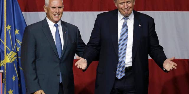 FILE - In this July 12, 2016 file photo, Indiana Gov. Mike Pence joins Republican presidential candidate Donald Trump at a rally in Westfield, Ind. Over the past two decades, Trump has disagreed with his vice-presidential pick on plenty of political issues, including immigration policy, entitlement programs and trade. On social issues above all, Trump and Pence arrive at the 2016 general election from very different paths. (AP Photo/Michael Conroy, File)