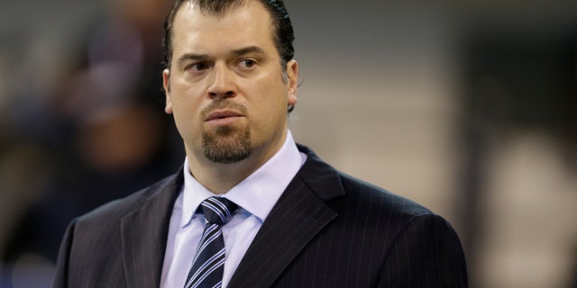 FILE - In this Dec. 15, 2013, file photo, Indianapolis Colts general manager Ryan Grigson watches warm-ups before an NFL football game against the Houston Texans in Indianapolis. The Colts are projected to be about $31 million under the salary cap heading into this offseason, and Grigson is looking to plug more holes on his team. (AP Photo/Darron Cummings, file)