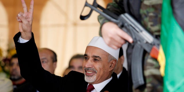 FILE - In this Sunday, Feb. 17, 2013 file photo, Libyan interim president, Mohammed el-Megarif flashes the victory sign to the crowd during the celebration of the second anniversary of the Libyan revolution in Benghazi, Libya. The head of Libya’s elected parliament has announced his resignation on Tuesday, May 28, 2013, just weeks after the body he led passed a law that bans officials who served under ousted dictator Moammar Gadhafi from senior government posts. Al-Megarif, who was Libya’s ambassador to India in 1980 before he joined the opposition in exile, teared up as he wished his country well and announced he is stepping down. (AP Photo/Mohammad Hannon, File)