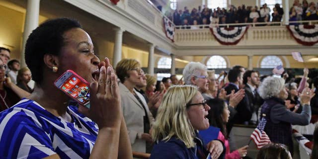 FILE- In this Feb. 29, 2016, file photo, supporters cheer Democratic presidential candidate Hillary Clinton as she speaks during a campaign event at the Old South Meeting House in Boston. The meeting house where colonists gathered to begin challenging British rule before the American Revolution and launched the Boston Tea Party has reopened. (AP Photo/Elise Amendola, File)