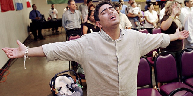 MESA, AZ - APRIL 9: Charlie Anaya, of Phoenix, prays during the worship service at Iglesia Palabra de Vida April 9, 2006 in Mesa, Arizona. There are approximately 300 evangelical Hispanic churches with 15,000 members in the Phoenix area that have been instrumental in organizing for immigrants rights. (Photo by Jeff Topping/Getty Images)