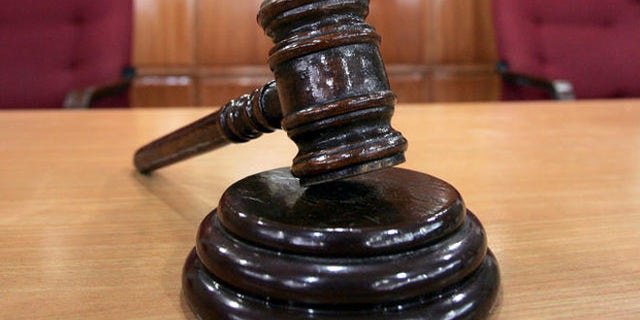A Sandiganbayan anti-graft court sheriff adjusts chairs inside a courtroom in Quezon city northeast of Manila, Philippines, Tuesday Sept. 11, 2007, where a verdict in ousted Philippine President Joseph Estrada's corruption trial will be announced on Wednesday. (AP Photo/Bullit Marquez)