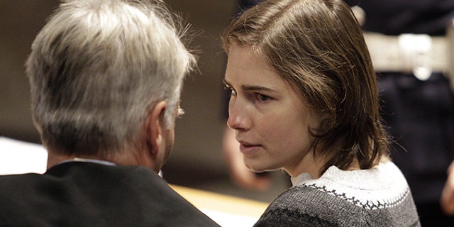 Dec. 11: Amanda Knox, right, talks to one of her lawyers during a hearing in her appeals trial, at Perugia's courthouse, Italy.