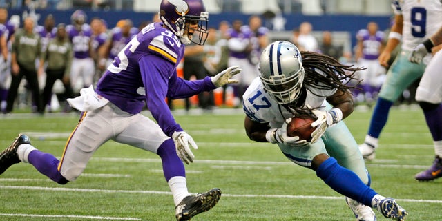 Minnesota Vikings' Marcus Sherels (35) is unable to keep Dallas Cowboys' Dwayne Harris (17) out of the end zone as Cowboys quarterback Tony Romo (9) watches from behind during the second half of an NFL football game, Sunday, Nov. 3, 2013, in Arlington, Texas. The Cowboys won 27-23. (AP Photo/Tim Sharp)