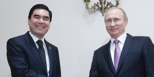 FILE- In this Nov. 23, 2015 file image, Russian President Vladimir Putin, right, shakes hands with his Turkmenistan counterpart Gurbanguly Berdymukhamedov during their meeting at the Gas Exporting Countries Forum, GECF, summit in Tehran, Iran. Lawmakers in the Central Asian nation of Turkmenistan have adopted Wednesday 14 September amendments to the country's constitution, paving the way for a life-long presidency for the incumbent leader Gurbanguly Berdymukhamedov. (Sergei Chirikov/Pool photo via AP file)
