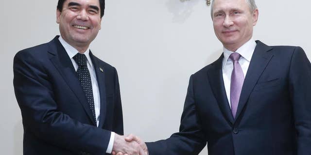 FILE- In this Nov. 23, 2015 file image, Russian President Vladimir Putin, right, shakes hands with his Turkmenistan counterpart Gurbanguly Berdymukhamedov during their meeting at the Gas Exporting Countries Forum, GECF, summit in Tehran, Iran. Lawmakers in the Central Asian nation of Turkmenistan have adopted Wednesday 14 September amendments to the country's constitution, paving the way for a life-long presidency for the incumbent leader Gurbanguly Berdymukhamedov. (Sergei Chirikov/Pool photo via AP file)
