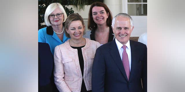 FILE - In this Sept. 21, 2015, file photo, Australia's Health Minister Sussan Ley, left in foreground, poses with Prime Minister Malcolm Turnbull, right, for a group photo after they were sworn in at Government House in Canberra, Australia. Ley stood aside while her travel expense claims are investigated. The scandal surrounding Ley's expense claims could trigger the first reshuffle of Turnbull's Cabinet since his government was re-elected in July 2106. Turnbull said Ley had agreed to stand aside on Monday, Jan. 9, 2017 without ministerial pay while the prime minister's department investigated whether her expense claims met guidelines. (AP Photo/Rob Griffith, File)