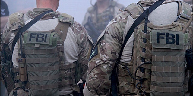 Members of the FBI's Hostage Rescue Team, or HRT, debrief after a training exercise at their headquarters in Quantico, Va.