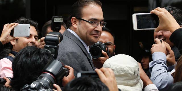 FILE - In this Aug. 5, 2016 file photo, outgoing Veracruz Gov. Javier Duarte arrives to the Attorney General's headquarters in Mexico City. Head of the office's branch for investigating federal crimes said in comments published online by the Attorney General's Office late Wednesday, Sept. 21, 2016, that it has taken over two corruption investigations involving Duarte. (AP Photo/Marco Ugarte, File)