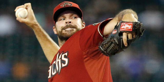Arizona Diamondbacks' Josh Collmenter throws a pitch against the Kansas City Royals during the first inning of a baseball game on Wednesday, Aug. 6, 2014, in Phoenix. (AP Photo/Ross D. Franklin)