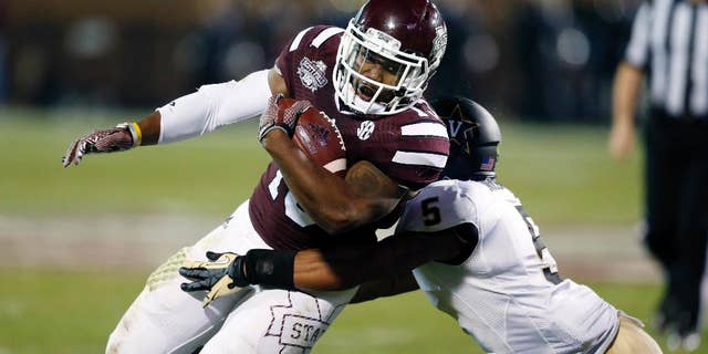 Mississippi State running back Josh Robinson (13) is tackled by Vanderbilt defensive back Torren McGaster (5) after a run for a first down in the first half of an NCAA college football game Saturday, Nov. 22, 2014, in Starkville, Miss. (AP Photo/Rogelio V. Solis)