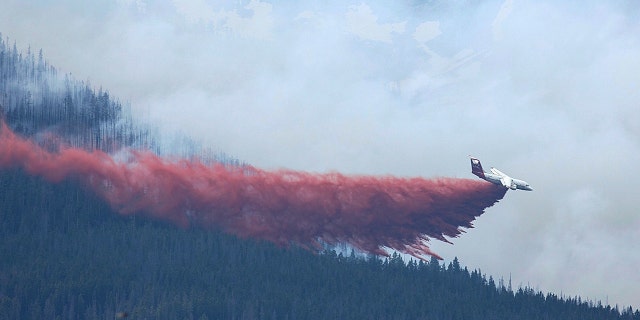 A plane drops fire retardant in Breckenridge, Colo., Wednesday, July 5, 2017.
