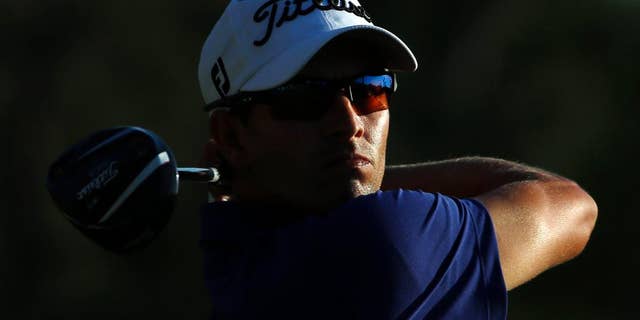 Adam Scott, of Australia, tees off during the third round of the Masters golf tournament Saturday, April 12, 2014, in Augusta, Ga. (AP Photo/David J. Phillip)