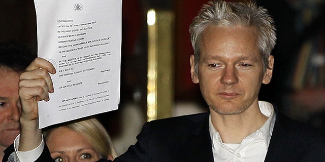 Dec. 16: WikiLeaks founder Julian Assange holds up a court document after he was released on bail in London.