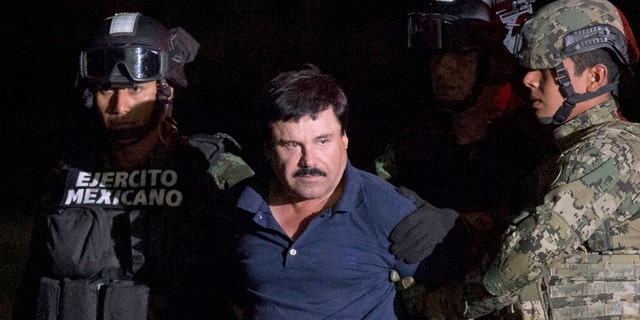 FILE - In this Jan. 8, 2016 file photo, Mexican drug lord Joaquin "El Chapo" Guzman is escorted by army soldiers  to a waiting helicopter, at a federal hangar in Mexico City, after he was recaptured from breaking out of a maximum security prison in Mexico. The History channel says it's developing a drama series focusing on Guzman's story. Last year, Guzman had broken out of prison and was on the run when he had a secret meeting with Mexican actress Kate del Castillo and Sean Penn. The actor wrote about it for Rolling Stone. (AP Photo/Rebecca Blackwell, File)