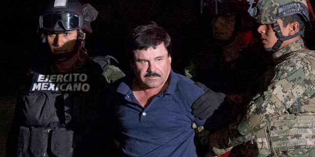 FILE - In this Jan. 8, 2016 file photo, Mexican drug lord Joaquin "El Chapo" Guzman is escorted by army soldiers to a waiting helicopter, at a federal hangar in Mexico City, after he was recaptured from breaking out of a maximum security prison in Mexico. The History channel says it's developing a drama series focusing on Guzman's story. Last year, Guzman had broken out of prison and was on the run when he had a secret meeting with Mexican actress Kate del Castillo and Sean Penn. The actor wrote about it for Rolling Stone. (AP Photo/Rebecca Blackwell, File)