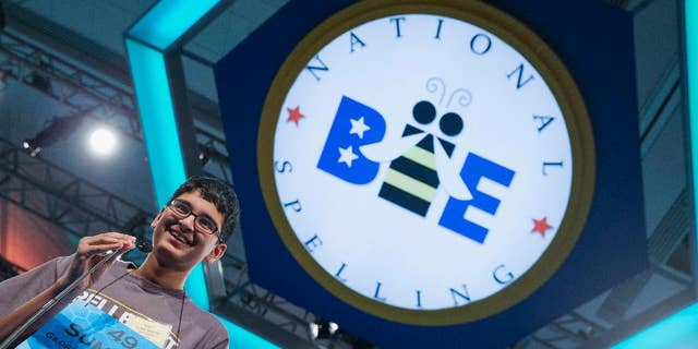 Summedh Garimella of Duluth, Ga., smiles as he spells the word "spelunker" during the preliminary round of the National Spelling Bee, Wednesday, May 28, 2014, in Oxon Hill, Md. (AP Photo/ Evan Vucci)