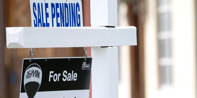 FILE - In this Thursday, Jan. 8, 2015, file photo, a "sale pending" sits atop a realty sign outside a home for sale in Surfside, Fla. The National Association of Realtors releases its pending home sales index for June on Wednesday, July 29, 2015. (AP Photo/Wilfredo Lee, File)