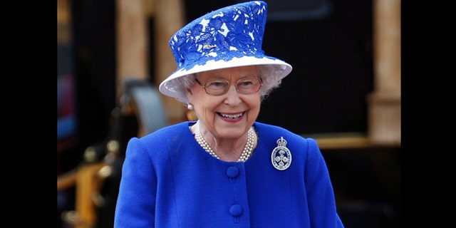 June 15, 2013: Britain's Queen Elizabeth II as the Guards march past outside Buckingham Palace after the Trooping The Colour, at the Horse Guards Parade in London. Queen Elizabeth II is celebrating her birthday with traditional pomp and circumstance, but without her husband by her side.