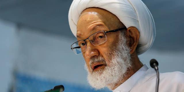 In this photo taken Nov. 21, 2014, Sheik Isa Qassim, Bahrain's top Shiite Muslim cleric, speaks during midday prayers Friday, in the village of Diraz, Bahrain. Bahrain’s leading Shiite opposition group says security forces have raided the home of the country’s most prominent Shiite cleric. (AP Photo/Hasan Jamali)