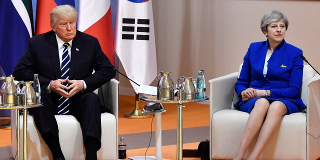 US President Donald Trump and Britain's Prime Minister Theresa May sit at the start of the "retreat meeting" on the first day of the G-20 summit in Hamburg, northern Germany, on Friday July 7, 2017 . Leaders of the world's top economies will gather from July 7 to 8, 2017. (John MacDougall/Pool Photo via AP)