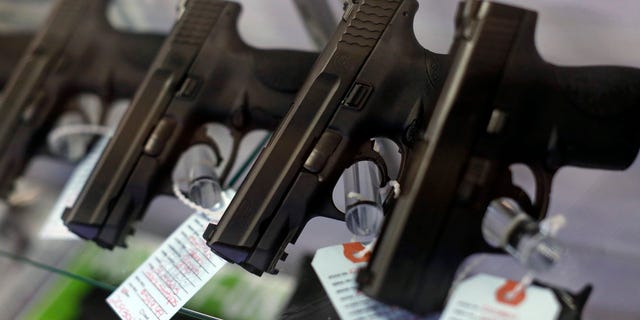 FILE -- Handguns are seen for sale in a display case.