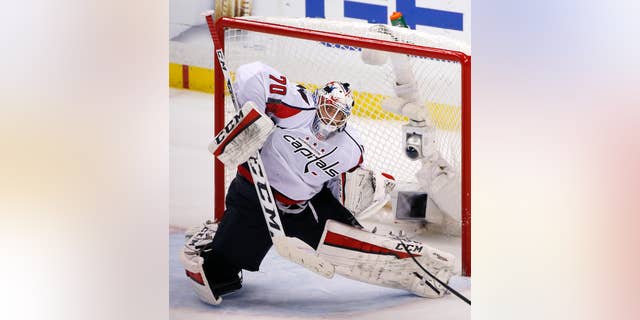 FILE - In this May 10, 2016 file photo, Washington Capitals goalie Braden Holtby blocks a shot during the third period of Game 6 in an NHL hockey Stanley Cup Eastern Conference semifinals against the Pittsburgh Penguins in Pittsburgh. Vezina Trophy finalist Holtby will represent the Washington Capitals in the annual Capital Pride Parade on Saturday, June 11, 2016, which the goaltender hopes is just the start of his involvement in the pro-gay-rights movement. (AP Photo/Gene J. Puskar, File)