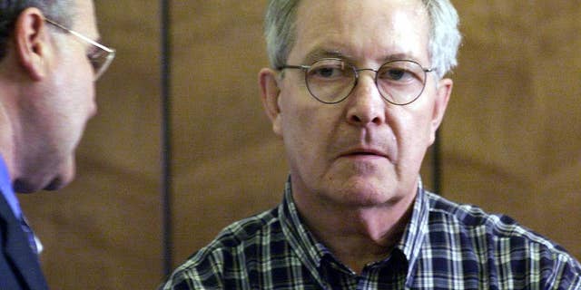 FILE - In this May 8, 2002, file photo, retired Catholic priest, the Rev. Ronald Paquin, right, talks with his Attorney, Kevin Reddington, left, during arraignment in District Court in Haverhill, Mass. Paquin was indicted Tuesday, Feb. 7, 2017, in Maine on 29 counts of sexual misconduct dating to the 1980s. Freed in 2015, Paquin was a central figure in the Boston archdiocese's sex abuse scandal. In 2002, he pleaded guilty to raping an altar boy. (Tom Landers/The Boston Globe via AP, Pool, File)