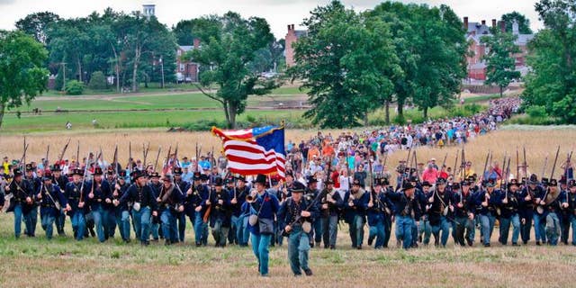 The Iron Brigade charges up McPherson's Ridge during the 150th Anniversary of the Battle of Gettysburg on July 1, 2013.