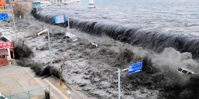 March 11, 2011: A wave approaches Miyako City from the Heigawa estuary in Iwate Prefecture after the magnitude 8.9 earthquake struck the area