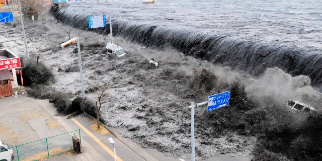 March 11, 2011: A wave approaches Miyako City from the Heigawa estuary in Iwate Prefecture after the magnitude 8.9 earthquake struck the area