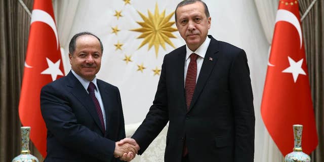 Turkish President Recep Tayyip Erdogan, right, and President of Iraq'a northern Kurdish region, Massoud Barzani, shake hands before a meeting in Ankara, Turkey, Wednesday, Dec. 9, 2015. Turkish Prime Minister Ahmet Davutoglu on Wednesday defended his country's deployment of additional forces to Iraq last week, saying it was an "act of solidarity" with Iraq's fight against the Islamic State group. Turkey has stationed troops at a base outside of the Iraqi city of Mosul since last year as part of a training mission coordinated with the Iraqi government in Baghdad. (AP Photo/Yasin Bulbul, Presidential Press Service, Pool )