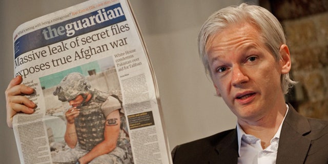 July 26: WikiLeaks founder Julian Assange holds up a copy of Britain's Guardian newspaper during a press conference in London.