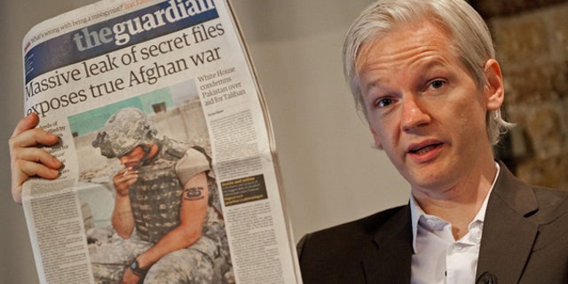 Julian Assange's brother and father speak out over his detainment, call for charges to be dropped 2 July 26: WikiLeaks founder Julian Assange holds up a copy of Britain's Guardian newspaper during a press conference in London.