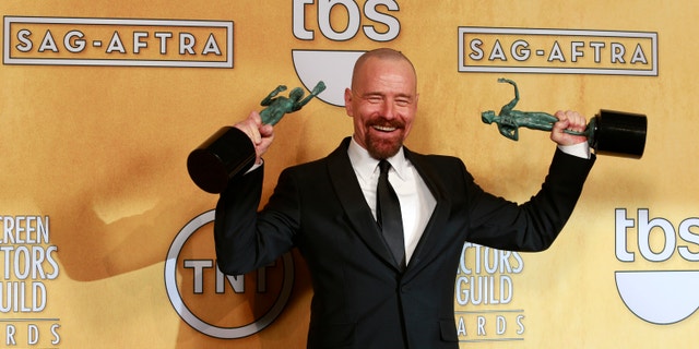Bryan Cranston poses backstage with his awards for outstanding male actor in a drama series for "Breaking Bad" and for outstanding cast in a motion picture for "Argo" at the 19th annual Screen Actors Guild Awards in Los Angeles, California January 27, 2013.