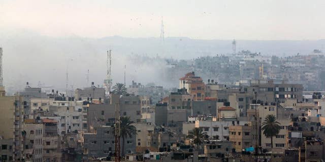 Smoke from Israeli strikes rises over Gaza City , northern Gaza Strip, Sunday, July 20, 2014. Israel said it widened its ground offensive early Sunday, sending more troops into Gaza after demolishing more than a dozen Hamas tunnels and intensifying tank fire on border areas. Since the start of Israel-Hamas fighting almost two weeks ago, over 300 Palestinians were killed and 2,700 wounded in Israeli air and artillery strikes, according to Palestinian health officials. One-fourth of the deaths were reported since the start of the ground offensive late Thursday, the officials said.(AP Photo/Lefteris Pitarakis)