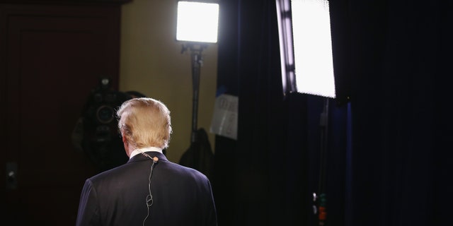 MILWAUKEE, WI - NOVEMBER 10: Republican presidential candidate Donald Trump gives an interview in the spin room after the Republican Presidential Debate sponsored by Fox Business and the Wall Street Journal at the Milwaukee Theatre on November 10, 2015 in Milwaukee, Wisconsin. The fourth Republican debate is held in two parts, one main debate for the top eight candidates, and another for four other candidates lower in the current polls. (Photo by Scott Olson/Getty Images)