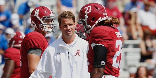 Alabama's offensive coordinator Lane Kiffin, centerr, gestures at running back Derrick Henry (27) before an NCAA college football game against Florida, Saturday, Sept. 20, 2014, in Tuscaloosa, Ala. (AP Photo/Brynn Anderson)
