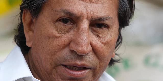 FILE - In this March 17, 2011 file photo, Peru's former President Alejandro Toledo campaigns for reelection at the Santa Anita wholesale market in Lima, Peru. Peruvian authorities said they searched Toledo's house on Saturday, Feb. 4, 2017 in a case involving alleged bribes from a construction firm under investigation in a major corruption probe in Brazil. Toledo currently is in Paris and denied the charges by telephone to Peruvian media. (AP Photo/Karel Navarro, File)