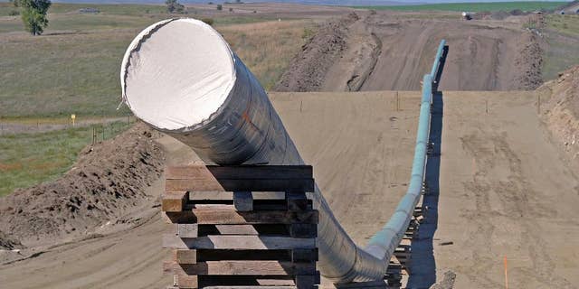 FILE - This Sept. 29, 2016 file photo, shows a section of the Dakota Access Pipeline under construction near the town of St. Anthony in Morton County, N.D. Texas-based Energy Transfer Partners, the company building the oil pipeline, asked a a federal judge on Tuesday, Jan. 17, 2017, to block the U.S. Army Corps of Engineers from launching a full environmental study of the $3.8 billion pipeline's disputed crossing of a Missouri River reservoir in North Dakota. (Tom Stromme/The Bismarck Tribune via AP, File)