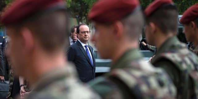 French president Francois Hollande reviews troops at the army base and command center for France's anti-terror 'Vigipirate' plan, dubbed 'Operation Sentinelle', in Vincennes, outside Paris, in July.