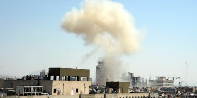 This photo released by the Syrian official news agency SANA, shows billowing smoke from a powerful explosion that shook Damascus in the central Marjeh district of Damascus, Syria, Tuesday, April. 30, 2013. State TV said the explosion caused casualties. The blast comes a day after the Syrian Prime Minister narrowly escaped an assassination attempt a heavily protected area of Damascus. (AP Photo/SANA)