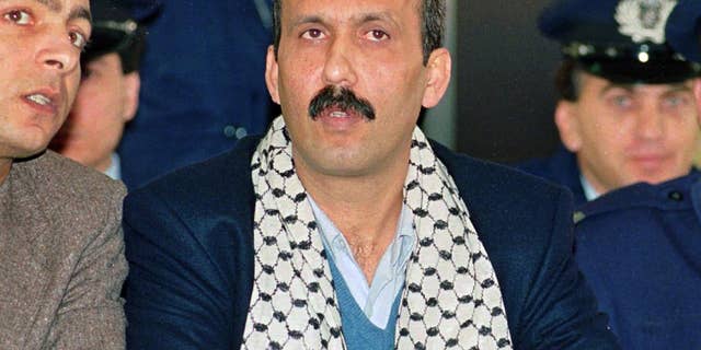 FILE - In this Dec. 12, 1991 file photo Mohammed Rashed, center, convicted of the 1982 PanAm jetliner bombing, listens to his interpreter, left, during his appeals court hearing in Athens, Greece. Rashed, the Jordanian-born Palestinian who’s been in immigration custody since he finished a prison sentence for putting a bomb on a plane in 1982 is expected to appear in a Buffalo courtroom in his bid for release. Rashed has been held at a facility outside Buffalo while the government has explored options to deport him. A federal court hearing is scheduled for Tuesday, June 7, 2016. (AP Photo/Aris Saris, File)
