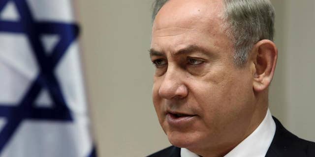 FILE - On this Sunday, February 12, 2017, file photo, Israeli Prime Minister Benjamin Netanyahu chairs the weekly cabinet meeting in Jerusalem. The Israeli Prime Minister is traveling to Washington this week for a high-level meeting with President Donald Trump who is suddenly clouded by uncertainty. After embracing Israel's hard nationalist right throughout his presidential campaign, Trump appears to have relaxed some of his positions on key issues since coming to power. (Gali Tibbon, pool via AP, file)