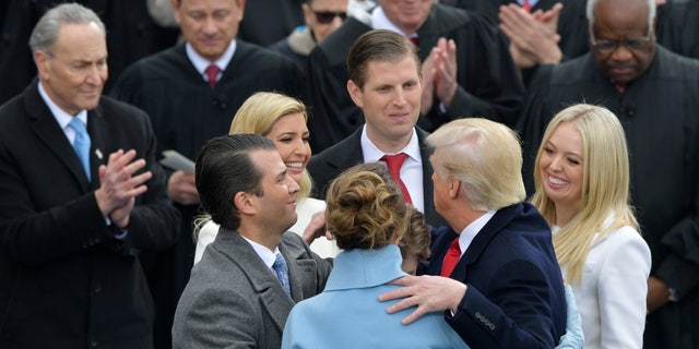 President Donald Trump hugs his family after taking the oath of office during the 58th Presidential Inauguration at the U.S. Capitol in Washington, Friday, Jan. 20, 2017.